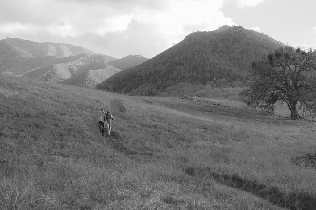 Couple together in an open field at the base of Mount Diablo in the Bay Area, California