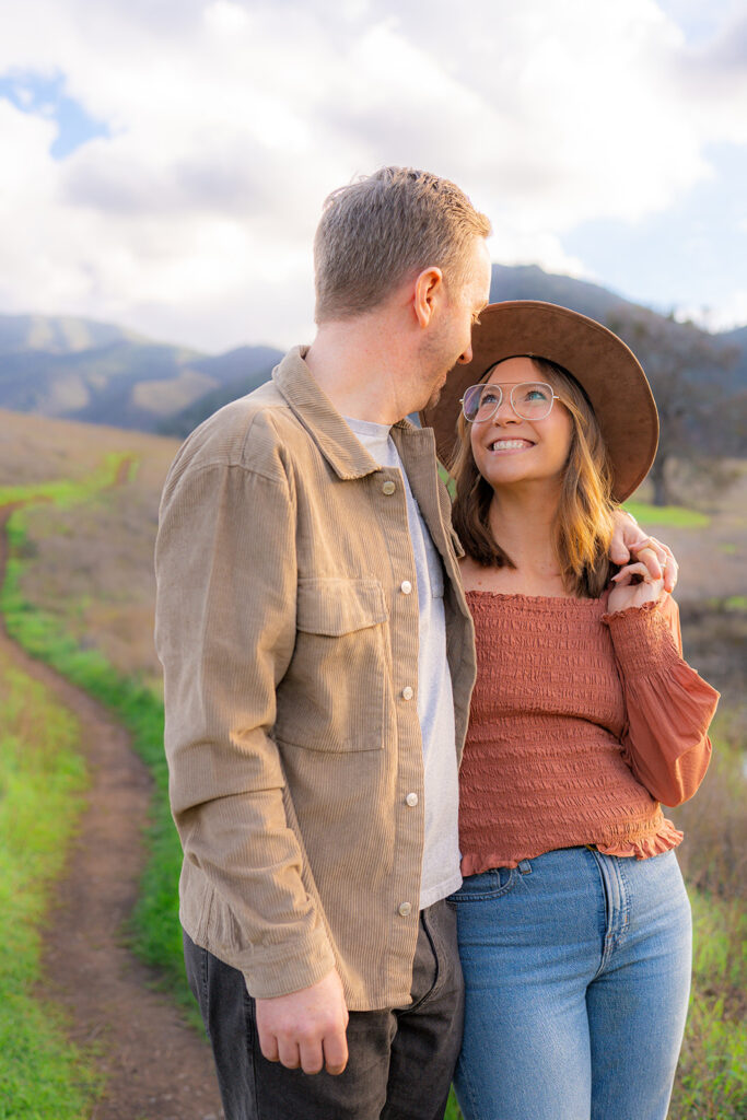 Couple together in an open field along the Mt. Diablo mountainside in the Bay Area.