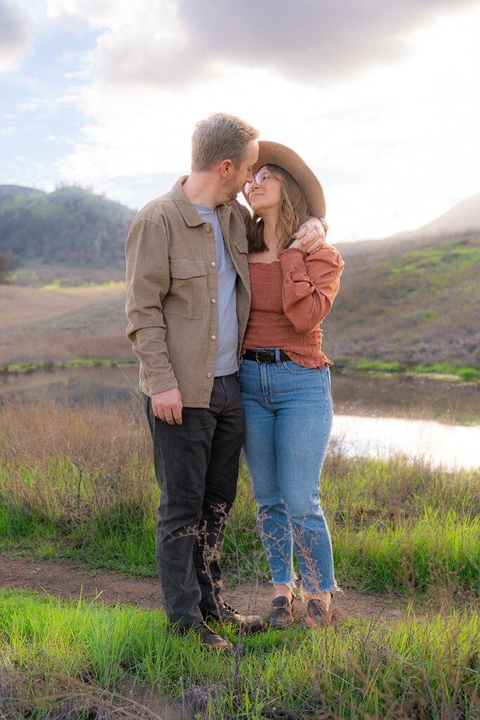 Couple together near the creek in an open field along the Mt. Diablo mountainside in the Bay Area, California
