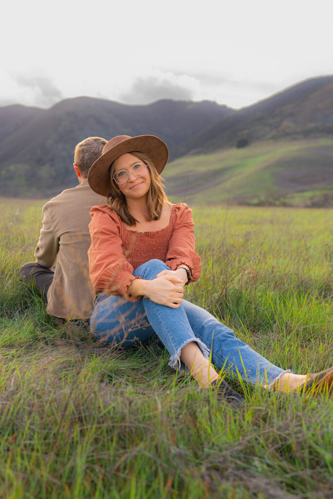 Couple sharing a romantic moment in an open field near a rustic water tower and Mt. Diablo in the Bay Area, California